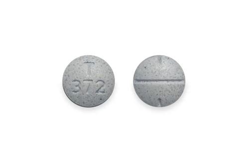 This white round pill with imprint T 10 on it has been identified as Famotidine 10 mg. . T 372 white round pill
